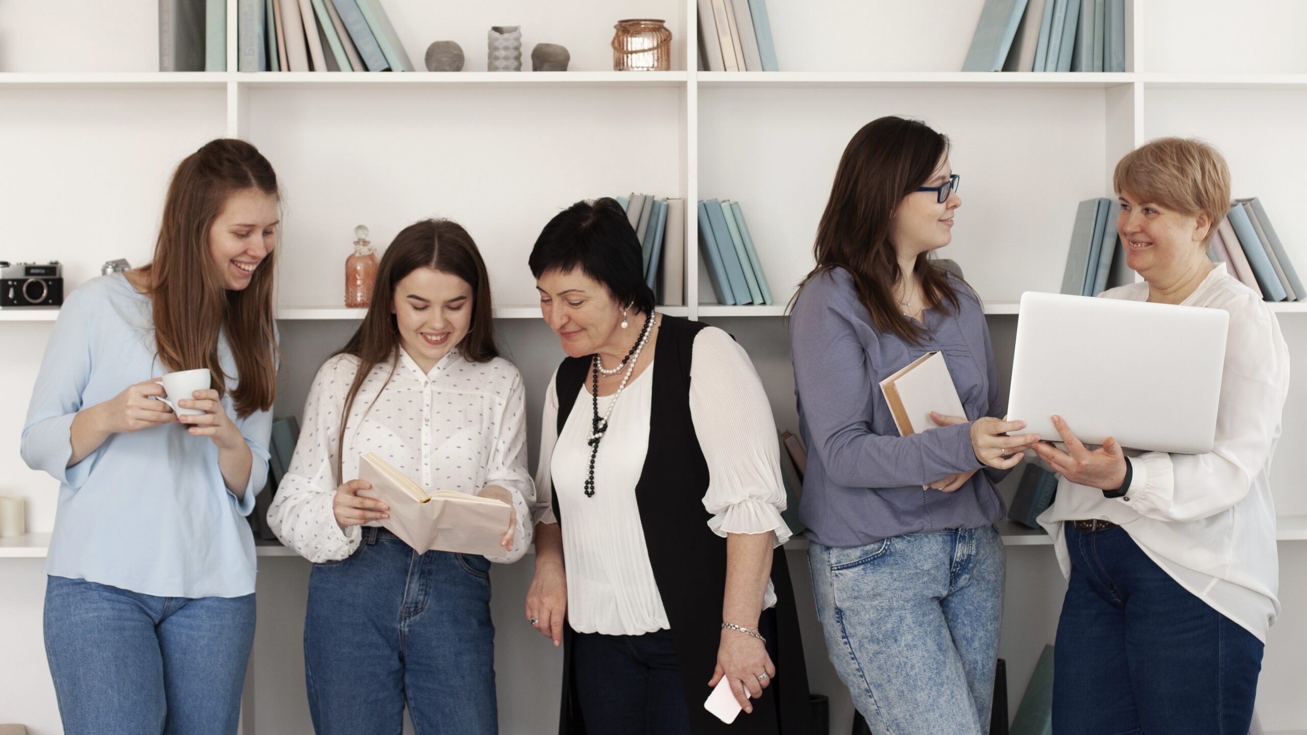 Women reading, discussing ideas, and working together in a supportive space that encourages women’s mental health and workplace well-being.